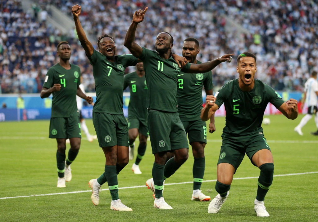 Nigerian footballers celebrating victory - Who own Nigeria?