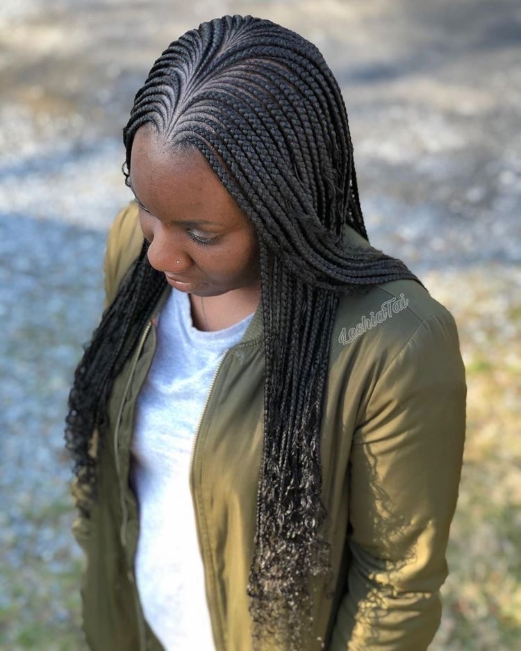 Woman on Tribal Braids with Curls – Sleek Middle Part Cornrows with Wet-Look Ends