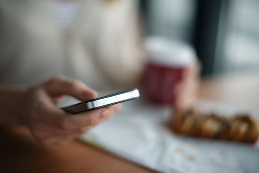 A person using a phone to text a message